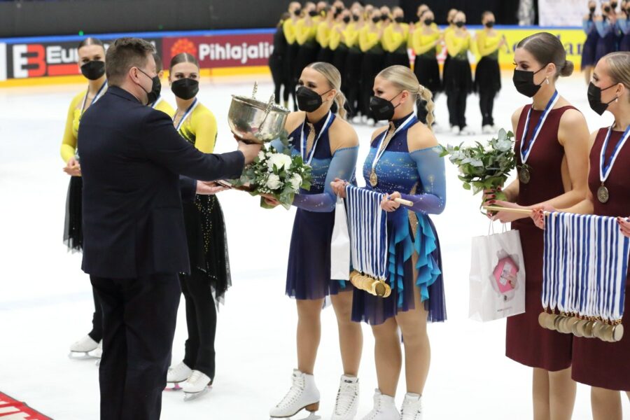 Helsinki Rockettes voitti Suomen mestaruuden Tampereella maaliskuussa 2022 Tampereella. Kapteeni Nona Vihma vastaanottaa palkintopokaalin Suomen Taitoluisteluliiton puheenjohtajalta Janne Korhoselta. 